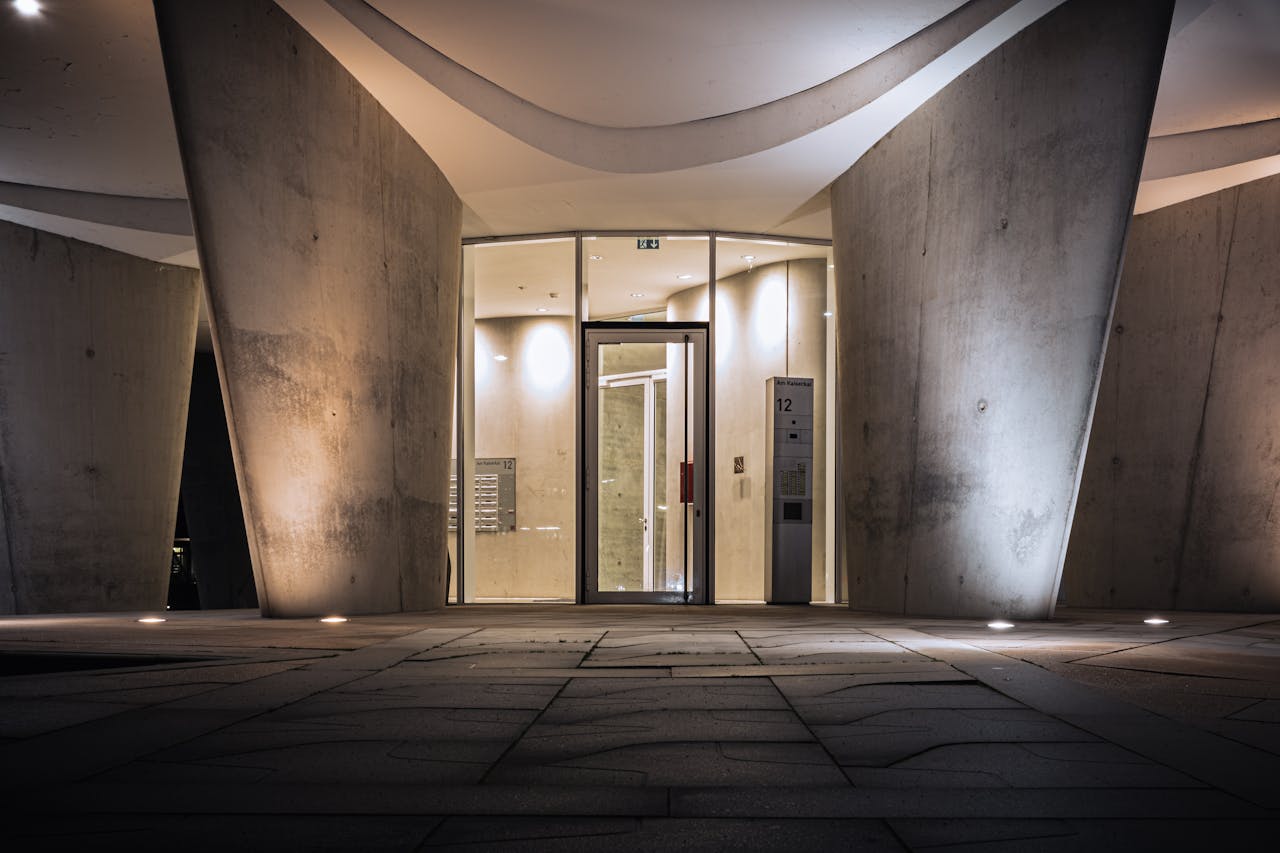 services-02 Modern architecture with illuminated entrance in Hamburg, showcasing futuristic design elements.