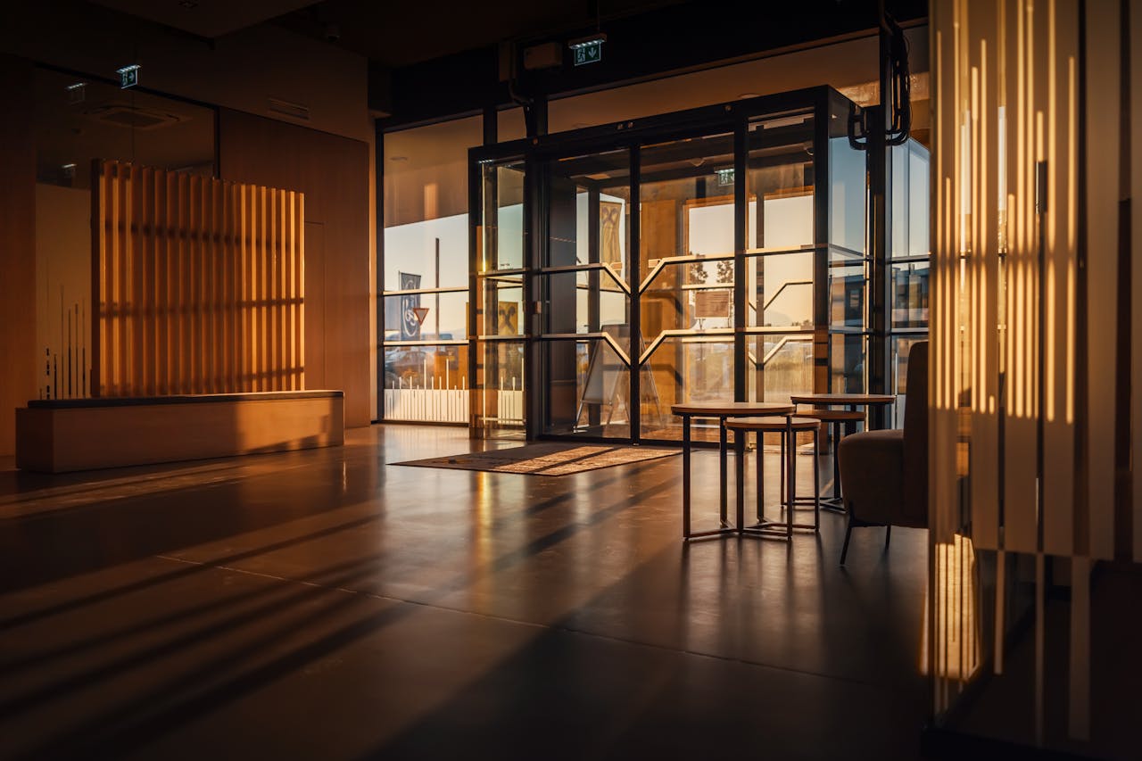 services-03 Sunlight streaming through a modern hotel lobby with glass doors in Steiermark, Austria.