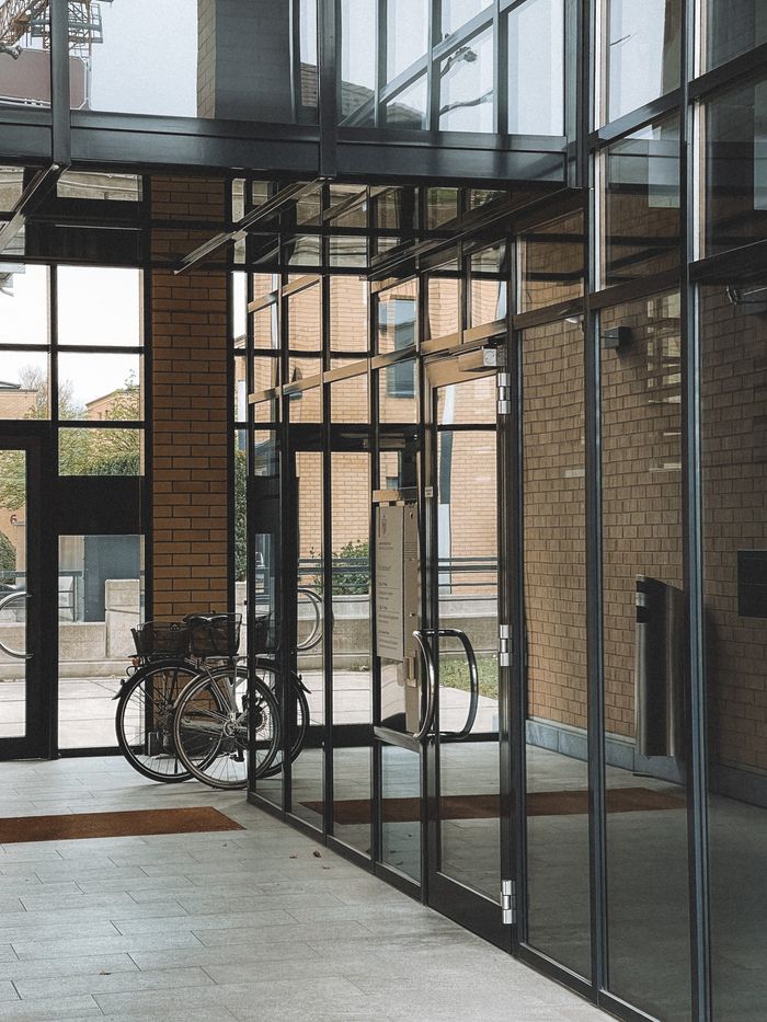 A sleek glass entrance of a modern residential building in Vaduz, Liechtenstein.
